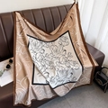 Detail of silk-like floral print scarf showing smooth texture and earth-tone pattern - Coffee Edge