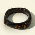 Macro view of wide resin bangle with amber leopard print and smooth polished texture - Vintage Tortoiseshell Style (31634-bra-by)