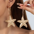 Detail of oversized gold starfish hoop earrings worn on a model for beach vacation style - Gold Starfish Hoop Earrings (29422-ear-G-6-EP)