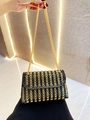 Close-up of luxury black evening bag with gold chain strap and sparkling rhinestone detail - Black