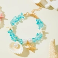 Detail of ocean-themed beaded bracelet with blue stones, pearls and starfish charms - Blue