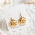 Detailed view of bohemian gold scallop earrings with pearls on white sand background - Irregular Organic Leaf Style (29421-5)