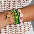 Detail of bohemian beach multi-layer bracelet with sea star charm and shells - Green