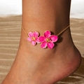 Detailed close-up of golden anklet featuring pink flowers on a sandy beach background - Rose Pink Flower Thin Chain Anklet (29834-2-rose)