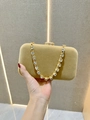 Detailed close-up of velvet evening clutch with sparkling rhinestone chunky chain strap - Champagne Gold