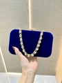 Detail of royal blue velvet evening clutch with oversized gold rhinestone chain handle - Sapphire Blue