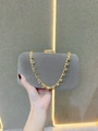 Close-up of velvet evening clutch with gold chain and sparkling crystal rhinestones - Gray