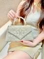 Detailed view of handmade pearl and rhinestone evening bag with intricate floral patterns - Gold