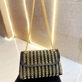 Elegant black evening bag with vertical gold chain pattern and metallic strap - Black