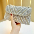 Close-up of evening clutch featuring exquisite silver pearls and sparkling rhinestones - Silver