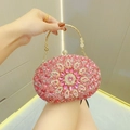 Elegante ovale Abendtasche mit rosa Strasssteinen, Blumenmotiv und goldenem Metallgriff - Fuchsia