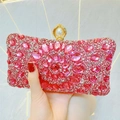 Detail of pink rhinestone evening clutch featuring crystal floral patterns and pearl clasp - Rose Red