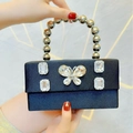 Elegant black satin evening clutch bag featuring a diamond butterfly buckle and beaded handle - Black