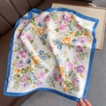 Close-up of a floral print square scarf with blue border on a leather sofa - 70*70cm / Blue Edge Floral (W-273-Blue Edge)
