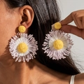 Detailed view of handmade raffia flower earrings featuring purple and white petals - Yellow Core Daisy (29604) / Light Purple
