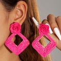 Detail of fuchsia woven raffia rose earrings with large diamond-shaped frame - Rose Red