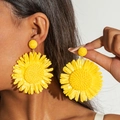 Detail of handmade raffia sunflower earrings with woven texture and lemon yellow petals - Bright Yellow