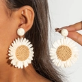 Detailed texture of handmade raffia daisy drop earrings with white woven petals - Off White