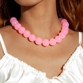 Close-up of pink oversized frosted acrylic beads on a fashion necklace worn by a model - Pink(27326)