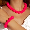 Detailed view of neon pink acrylic bead necklace and bracelet set on a model - Rose Red(27326-Set)