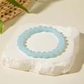 Detailed view of light blue beaded acrylic bracelet on white textured stone background - Light Blue