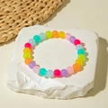 Detailed view of colorful candy-colored acrylic beads on a minimalist summer bracelet - Colorful