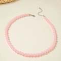 Macro view of light pink beaded choker necklace with adjustable silver lobster clasp - Light Pink
