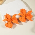 Close-up of orange matte enamel flower earrings with 3D layered irregular petals - Orange