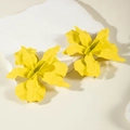Detailed view of matte yellow flower earrings with 3D petals on a white stone pedestal - Yellow