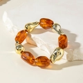Elastic beaded bracelet with gold metallic and amber resin beads on a stone background - Gold Irregular Metal Beads and Amber Resin Bracelet (30879)