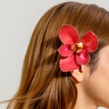 Detail view of a 3D printed red orchid hair clip worn on a model's hair for summer style - Red Orchid (30099-hp-red)