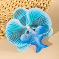 Close-up of a blue Phalaenopsis orchid hair clip with realistic fabric petal textures - Lake Blue