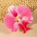 Macro detail of pink orchid hair clip showing realistic petal textures and center details - Pink