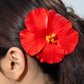 Close-up of a vibrant red hibiscus flower hair clip with yellow stamen on dark hair - Bright Red Hibiscus (31350-hp-red-EP)