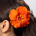 Detail of vibrant orange hibiscus flower hair clip with yellow stamen on black hair - Orange Red Hibiscus (31350-hp-ora-EP)