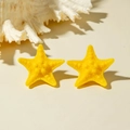 Detail of yellow starfish stud earrings with matte texture and realistic bumpy surface - Yellow