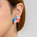 Close-up of a gradient resin daisy earring featuring blue, pink, and orange petals - Blue-Pink Gradient