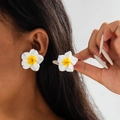 Macro detail of white resin frangipani flower earrings with yellow gradient center - White and Yellow Gradient