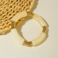 Minimalist beige acrylic beaded bracelet with golden spiral metal spacers in vintage style - Creamy White Curved Tube and Gold Coil Bracelet (31169)