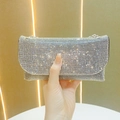 Macro shot of silver rhinestone surface on evening clutch bag with metal chain - Black