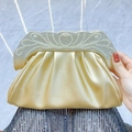 Golden clutch bag with pearl and rhinestone trim featuring pleated metallic texture - Gold