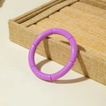 Close-up of a purple segment bamboo-style acrylic stretch bracelet on display - Purple