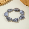 Bracelet élastique bohème avec perles de résine marbrées et espaceurs dorés - Gris