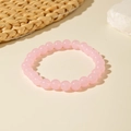 Elegant beaded bracelet featuring round pink quartz beads with a smooth polished finish - Pink