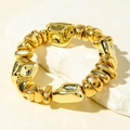 Polished gold beaded bracelet with organic sculptural shapes on a white stone base - Gold Flowing Irregular Bead Bracelet (31608)