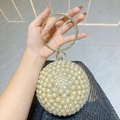 Spherical pearl evening bag with rhinestone circular handle and gold metal base - Gold