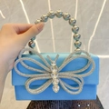Light blue satin evening bag featuring a large crystal butterfly and beaded handle - Blue