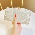 Close-up of white pleated evening clutch featuring a luxury gold knot clasp decoration - Apricot Standard No Chain