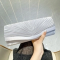Elegante silberne plissierte Umschlag-Clutch zu einem schwarzen Paillettenkleid - Silber