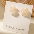 Macro detail of 3D cream white floral stud earrings with silver glitter on display card - Creamy White Glitter Translucent Flower Stud Earrings (5962-ear-apricot-2)